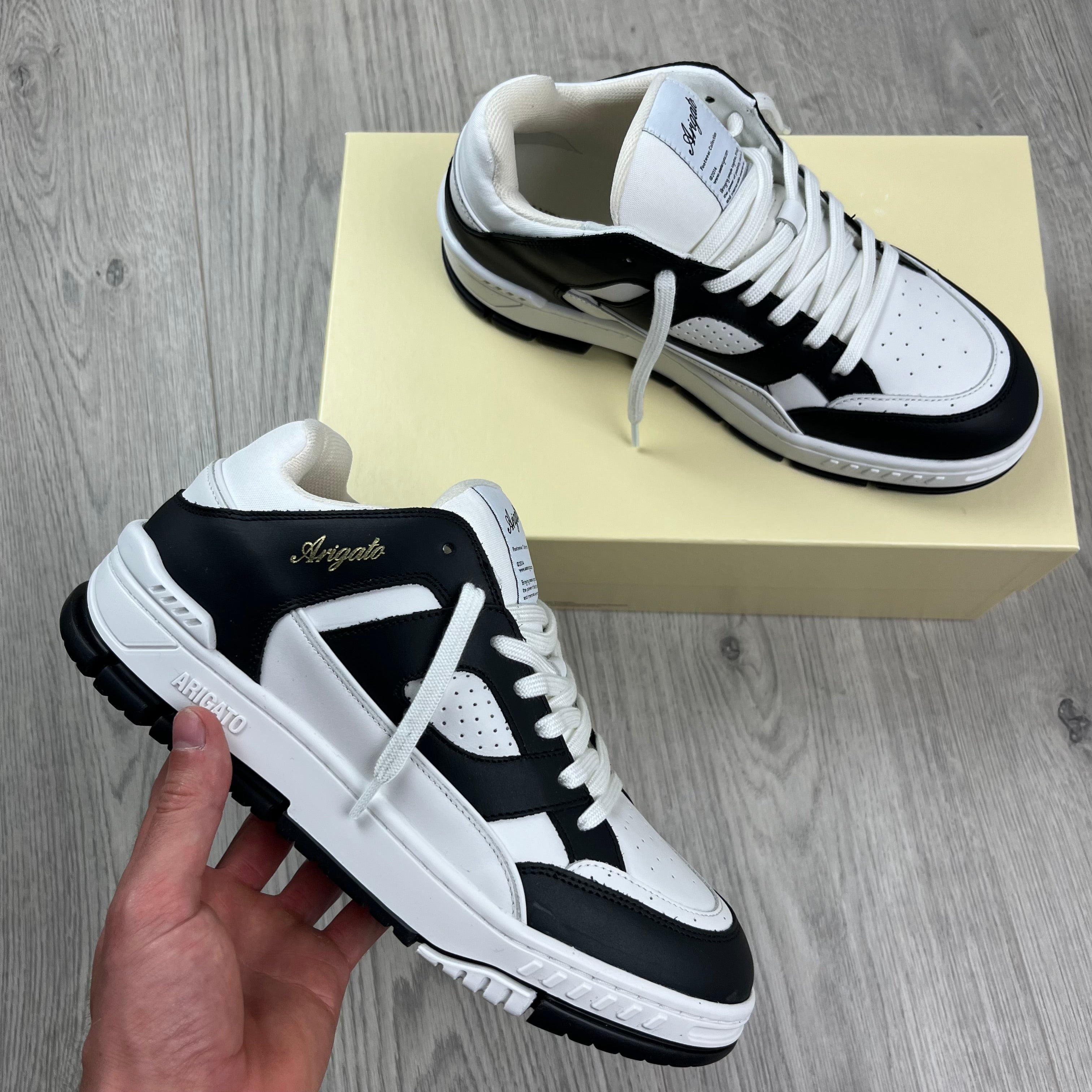 Men's Axel Arigato Arena Lo Sneakers in White/Black. On sale at Open Attire.