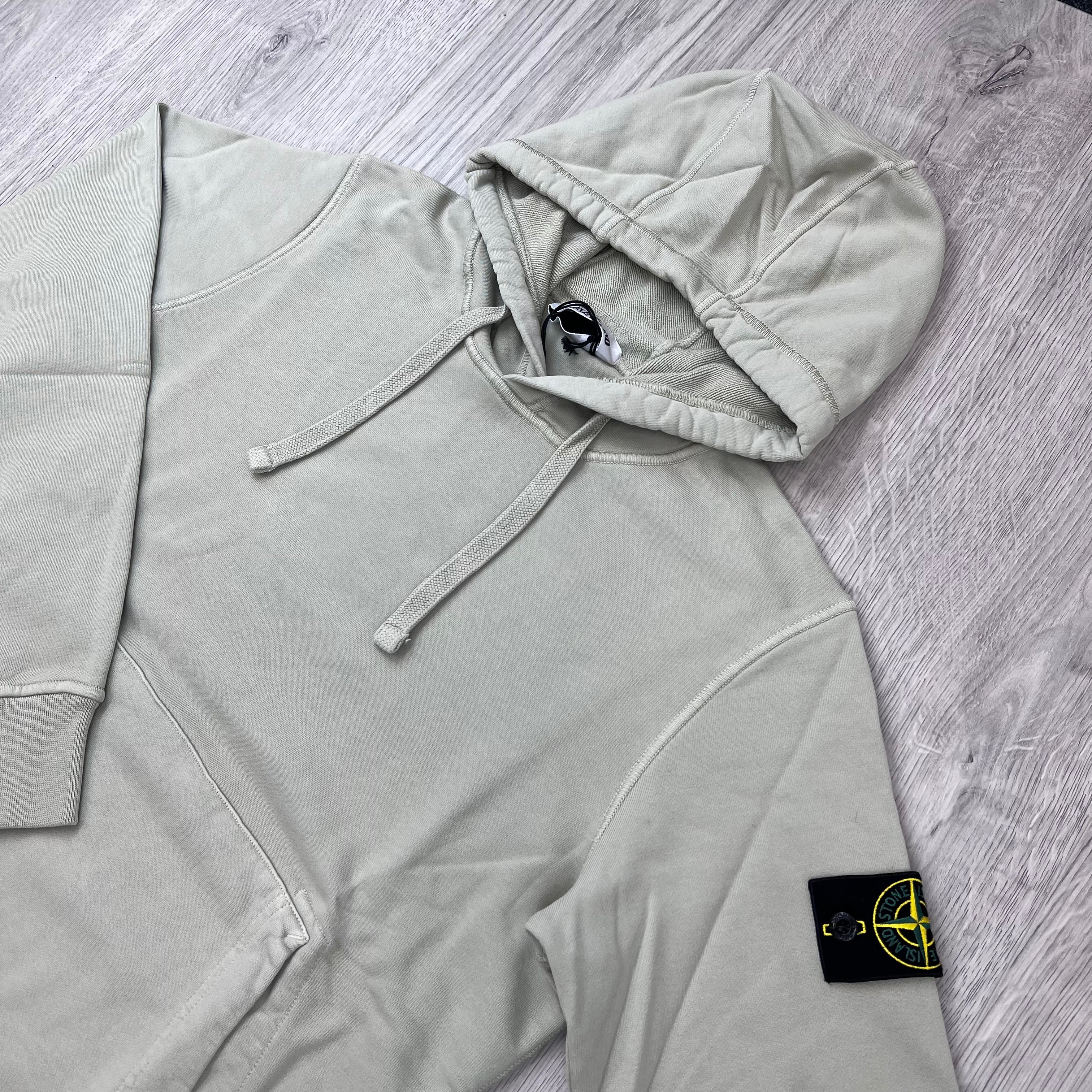 Angled view of a Stone Island Pullover Hoodie in Sand.