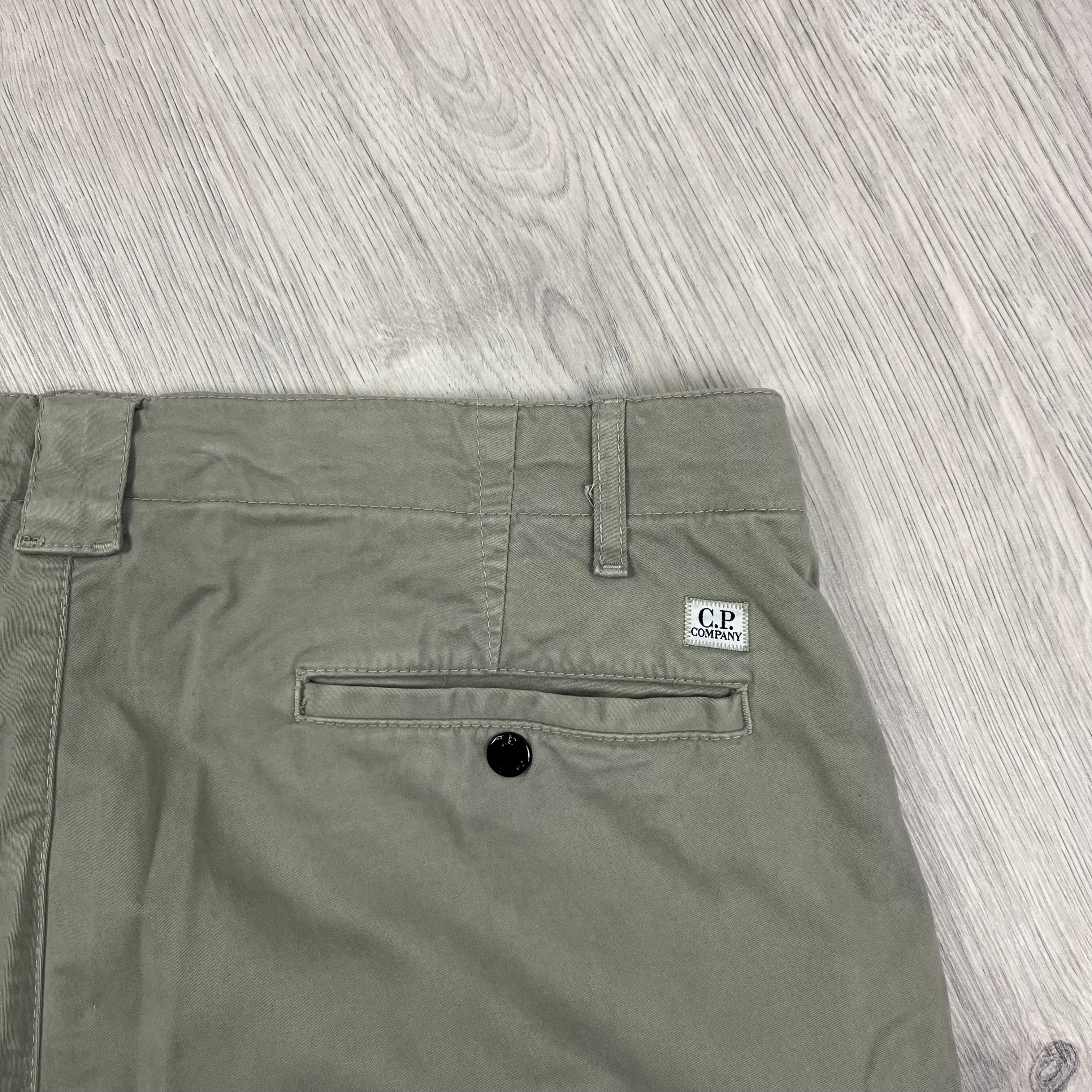 CP Company Stretch Sateen Ergonomic Lens Cargo Pants in Vintage Khaki. On sale at Open Attire.