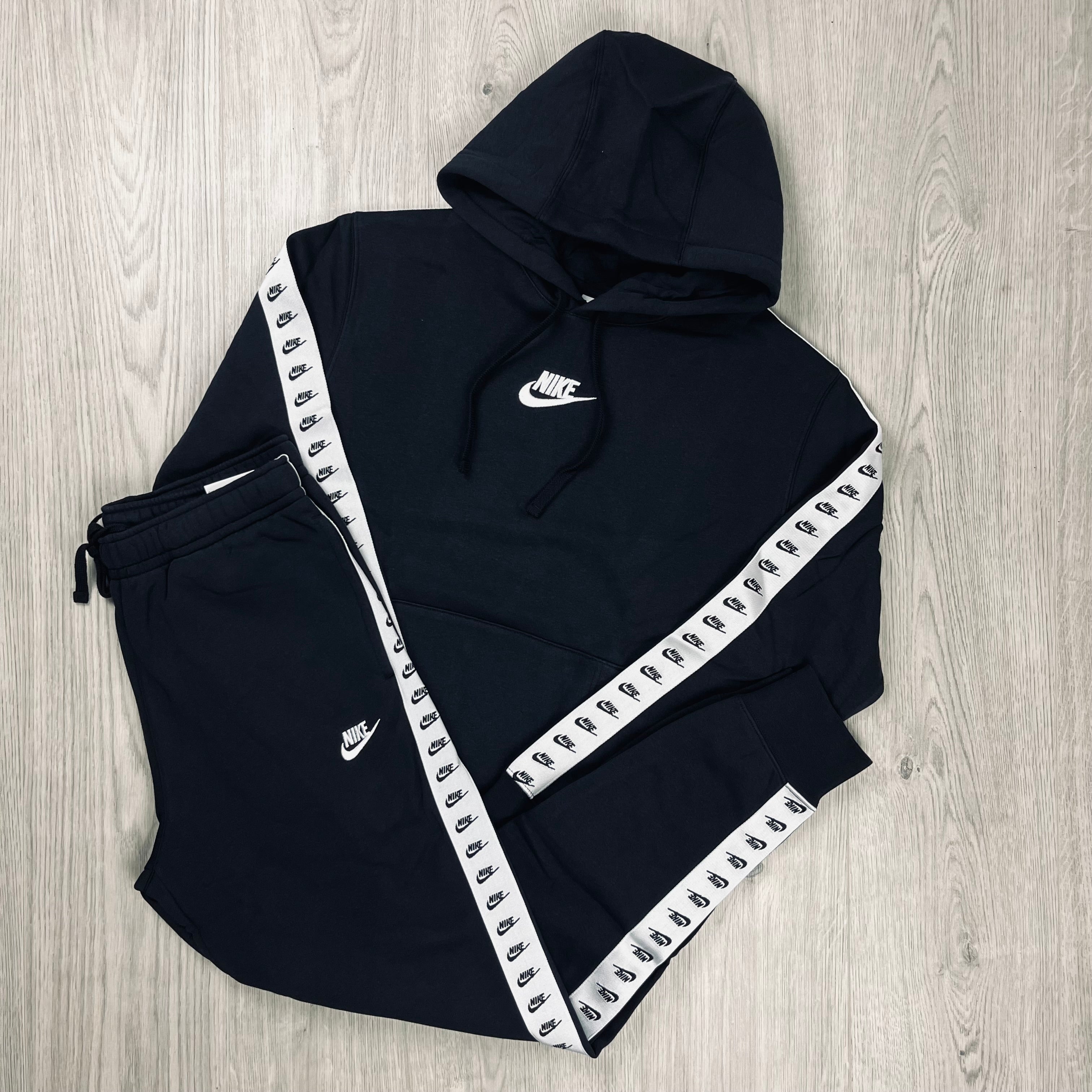 Nike tracksuit with white stripe on sale