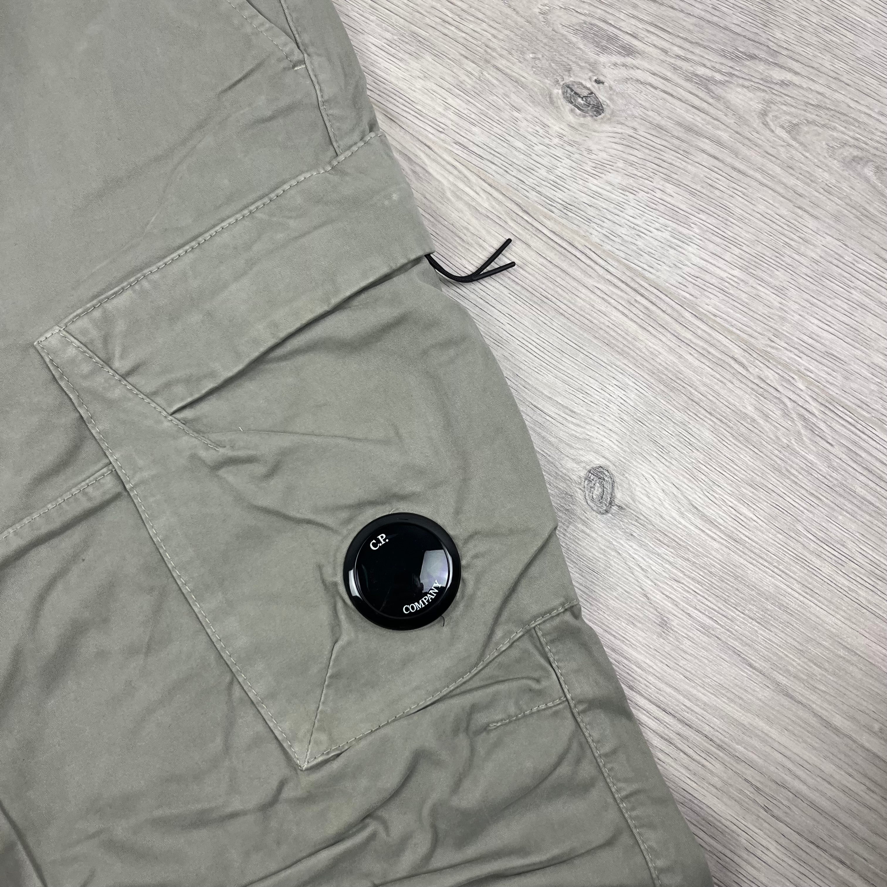 CP Company Stretch Sateen Ergonomic Lens Cargo Pants in Vintage Khaki. On sale at Open Attire.