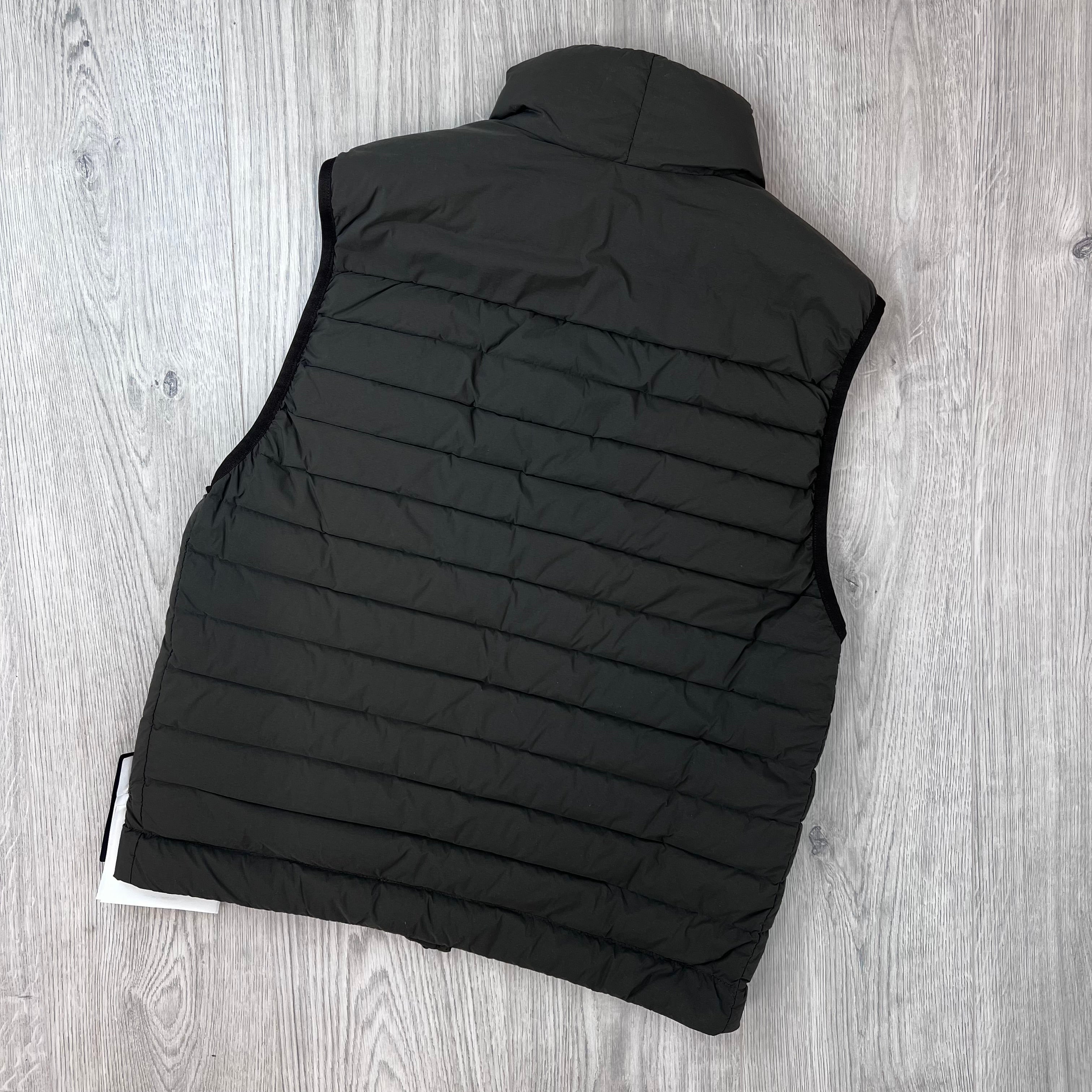 Rear view of the Stone Island Seamless Tunnel Nylon Down-TC Down Gilet in Coal Grey. 