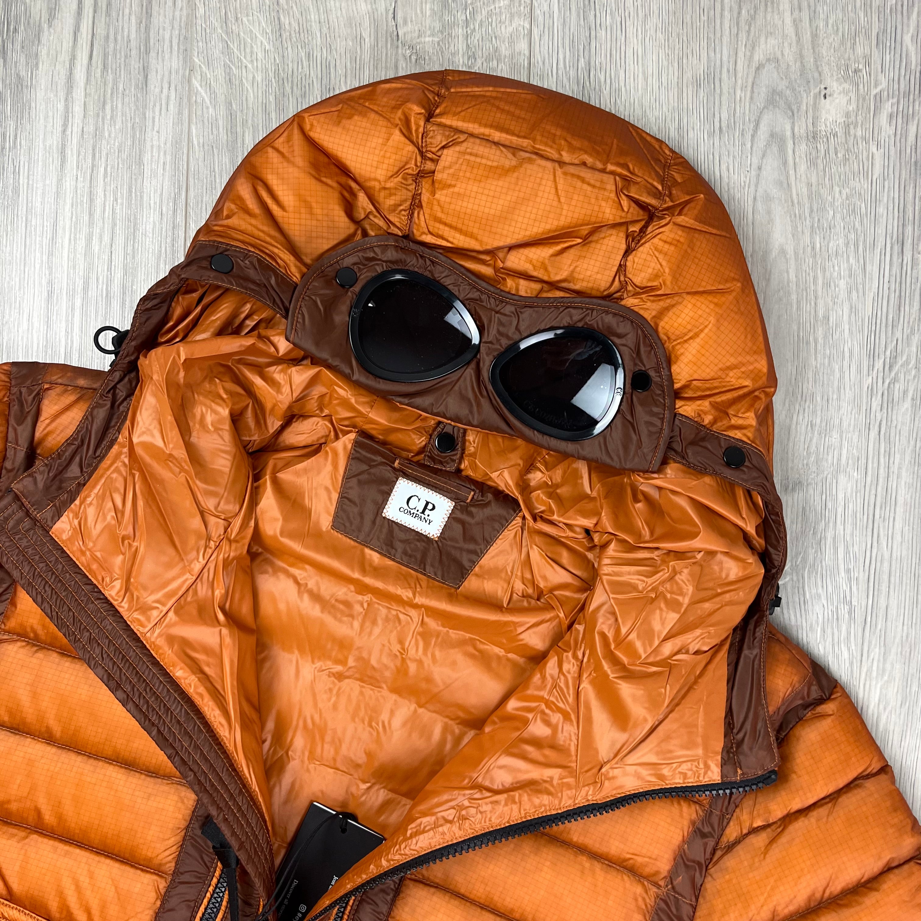 CP Company D.D. Shell Goggle Down Jacket in Bombay Brown. On sale at Open Attire.