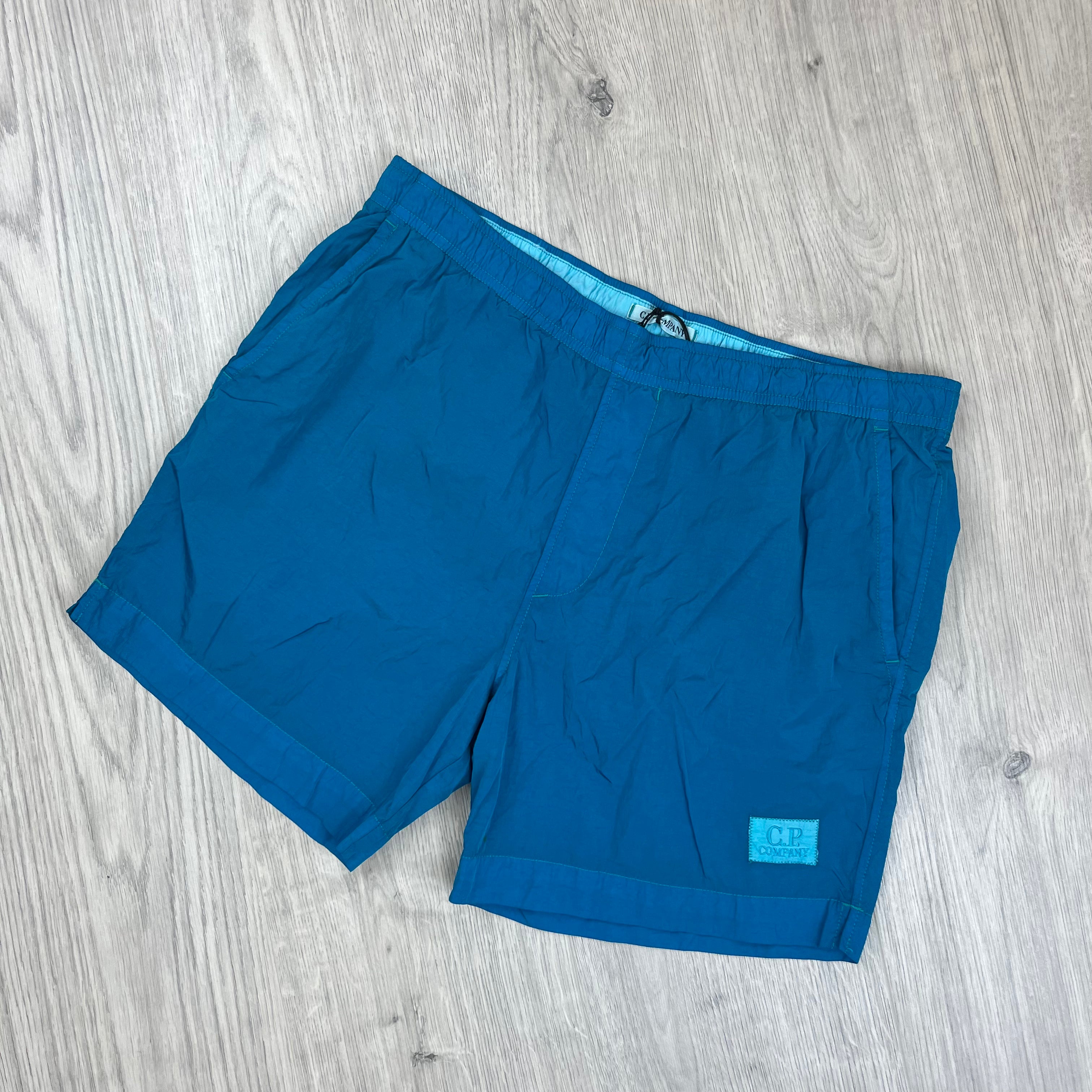 CP Company Eco Chrome-R Swim Shorts in Tile Blue. On sale at Open Attire.