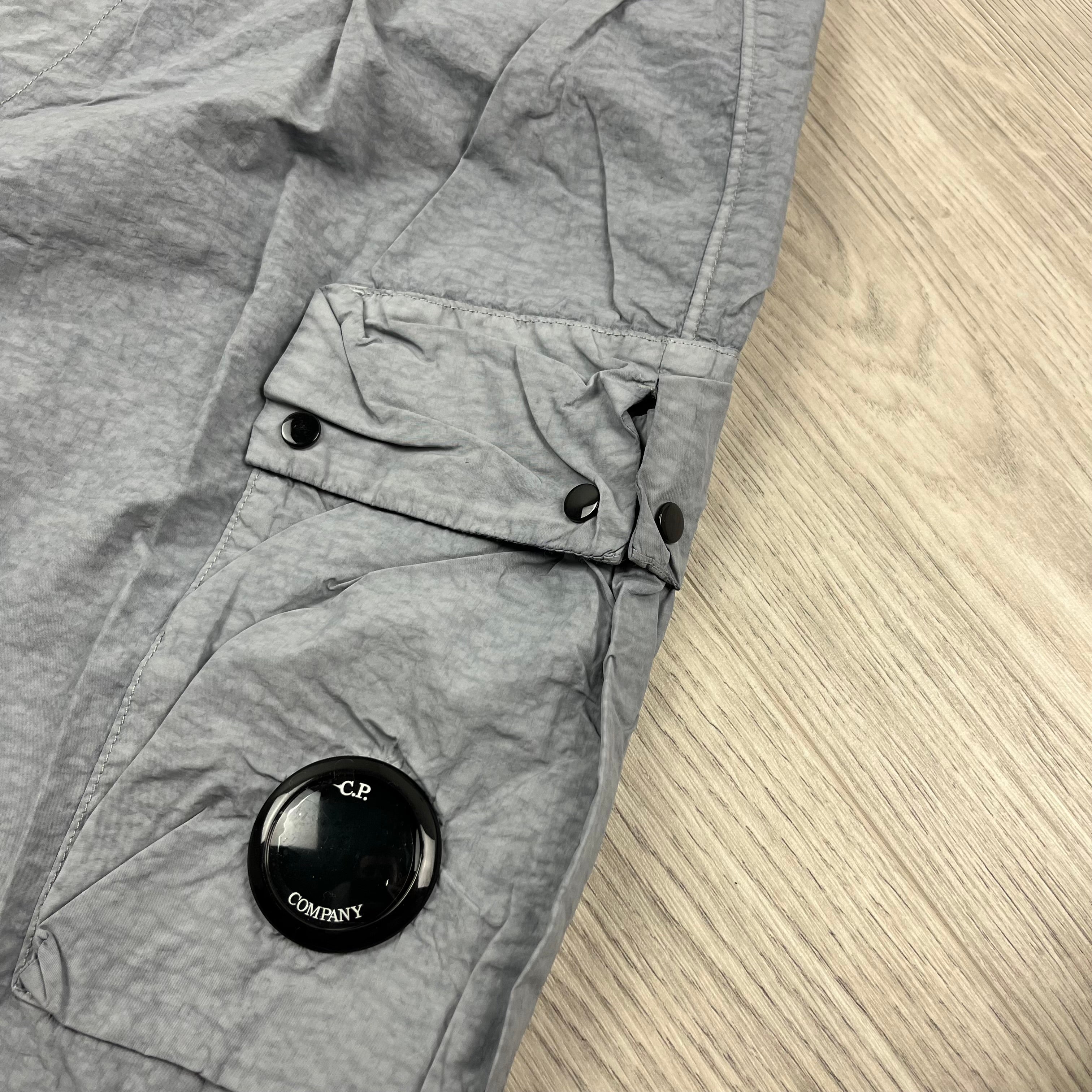 CP Company Flatt Nylon Lens Swim Shorts in Limestone Grey. On sale at Open Attire.