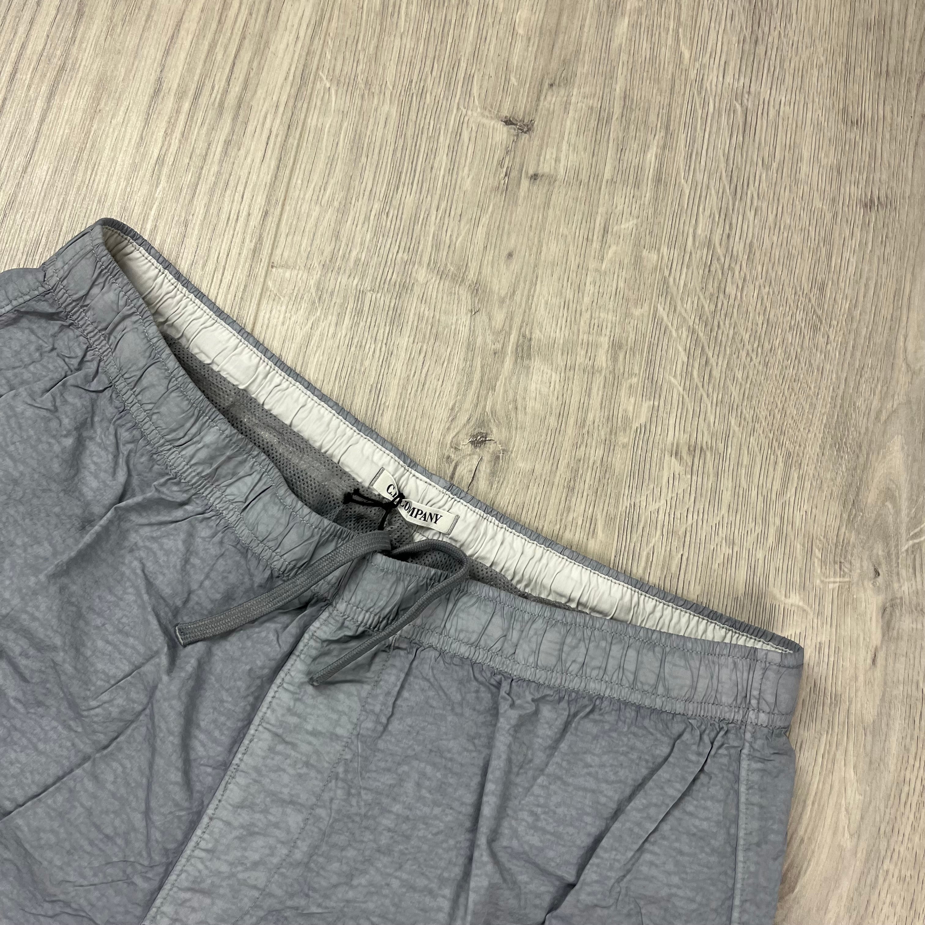 CP Company Flatt Nylon Lens Swim Shorts in Limestone Grey. On sale at Open Attire.