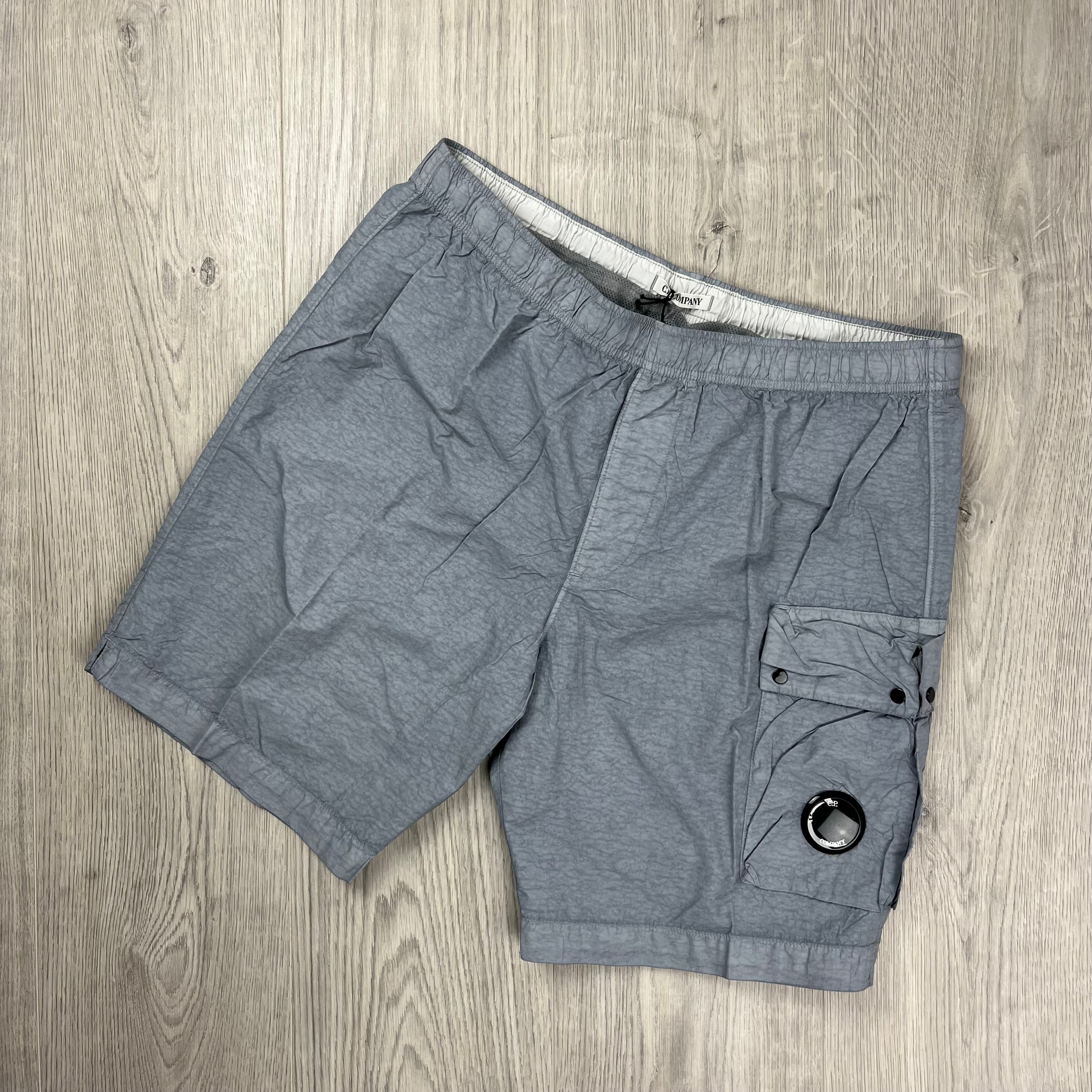 CP Company Flatt Nylon Lens Swim Shorts in Limestone Grey. On sale at Open Attire.