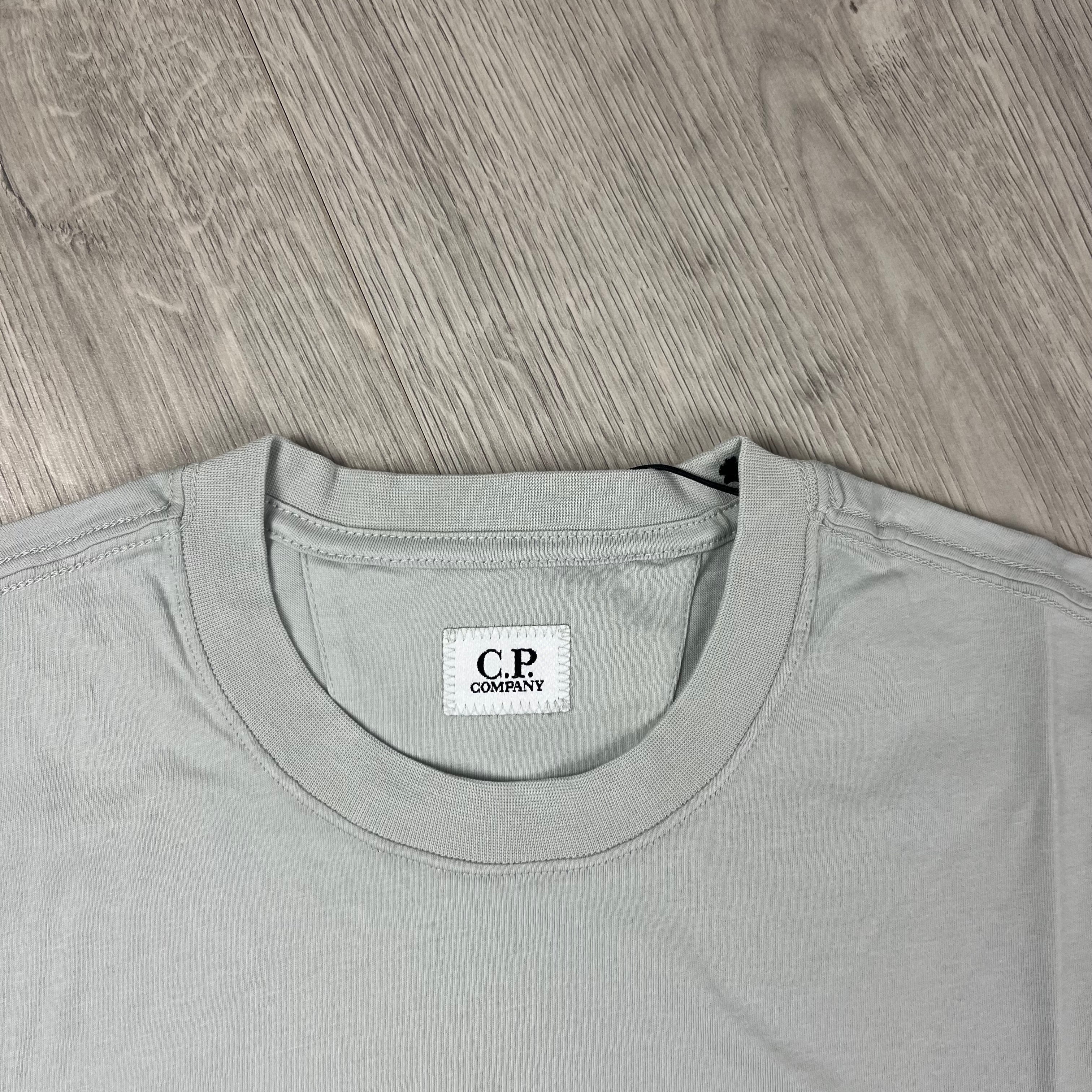 CP Company 30/1 Stamp Logo T-Shirt in Blue Fox. On sale at Open Attire.