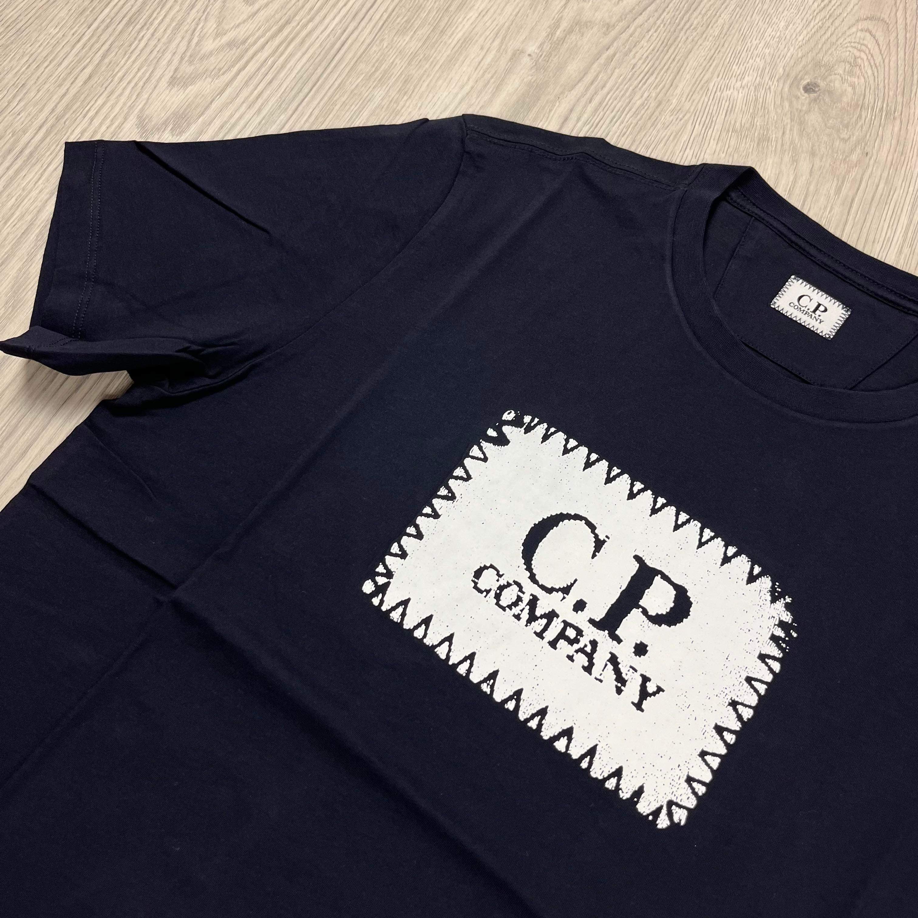 CP Company 30/1 Stamp Logo T-Shirt in Total Eclipse Navy Blue. On sale at Open Attire.