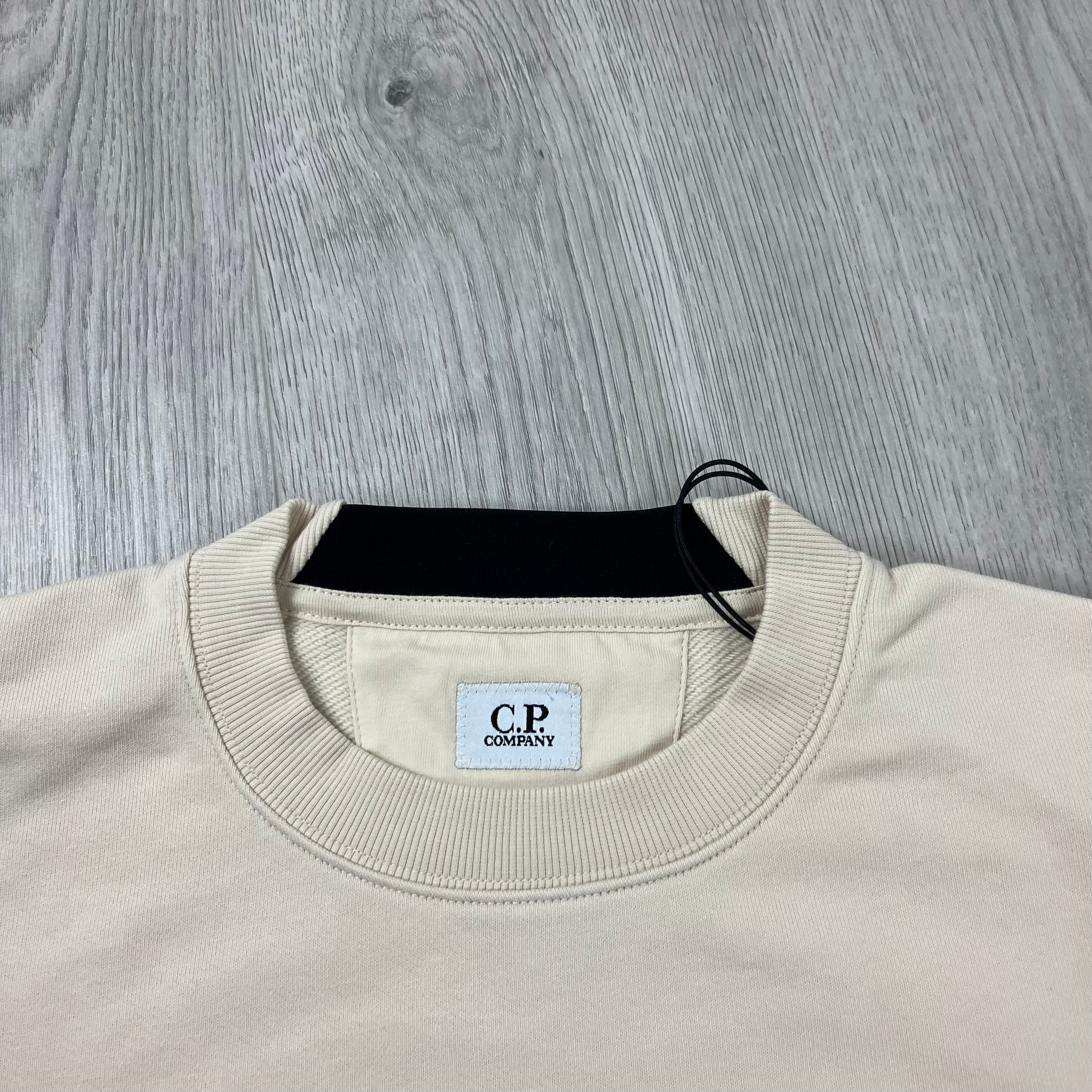 CP Company Diagonal Raised Fleece Lens Sweatshirt in Pistachio Shell. On sale now.