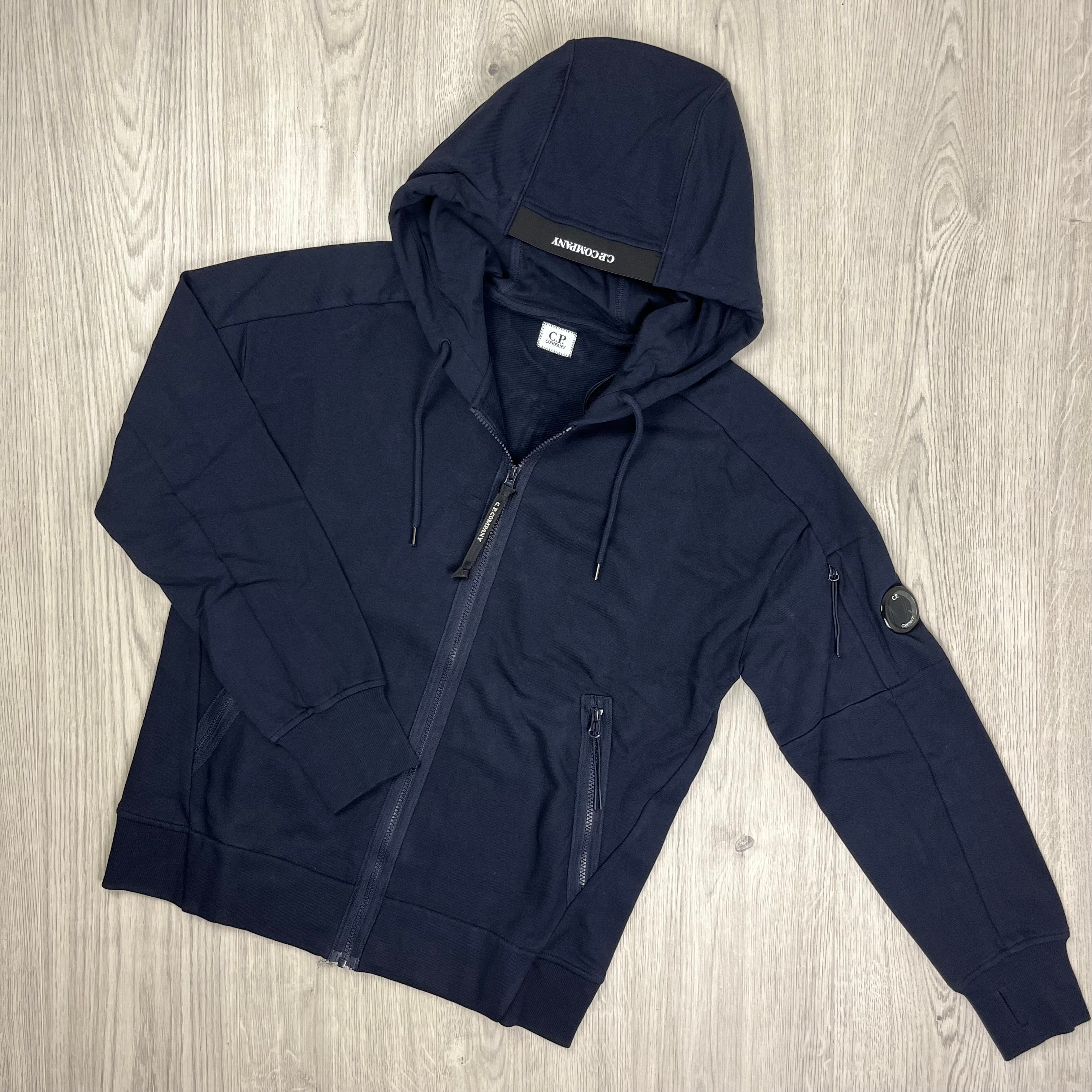 CP Company Diagonal Raised Fleece Zipped Hoodie with sleeve lens detail in Total Eclipse Navy Blue. On Sale at Open Attire.