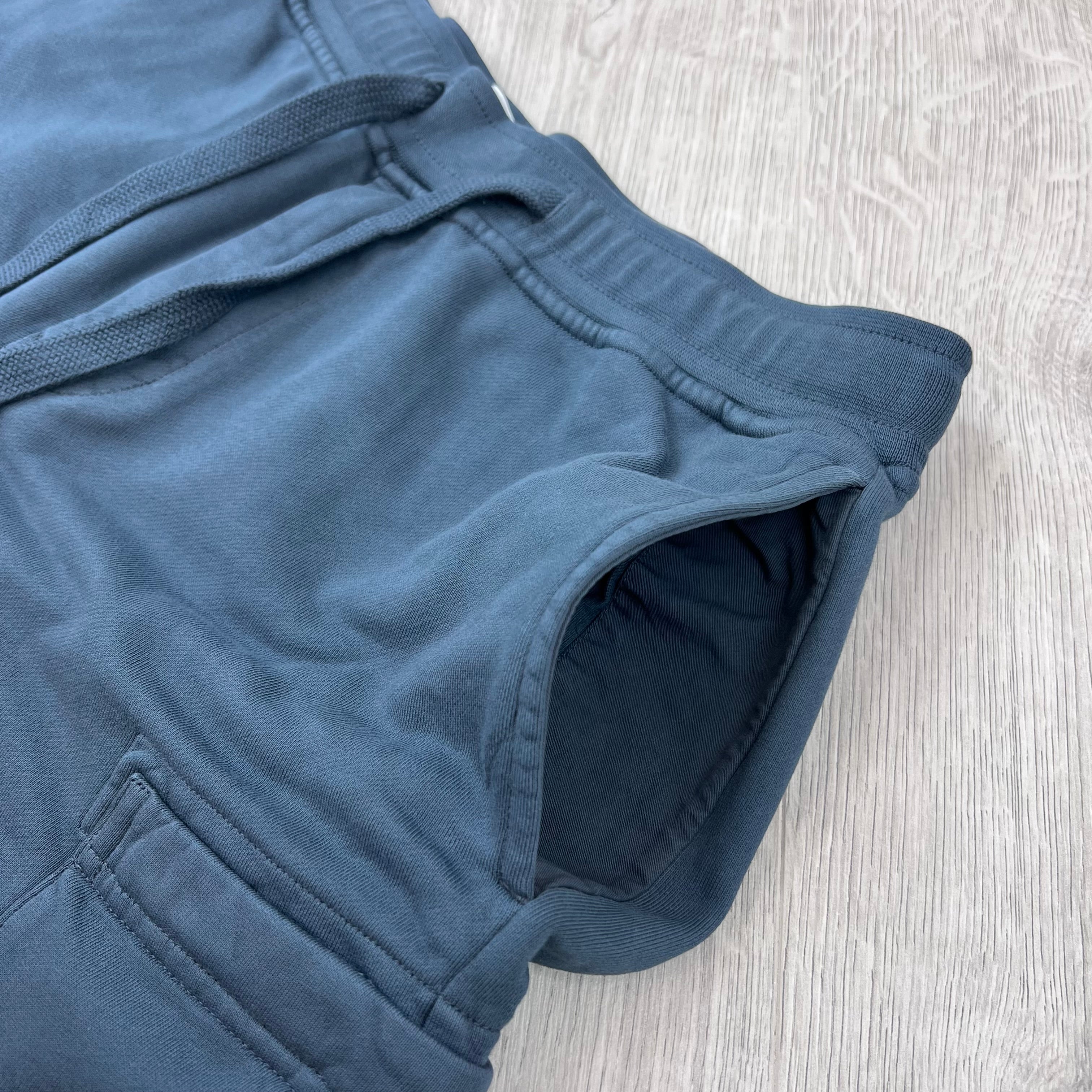 A close up view of the hand pockets on the Stone Island Jersey Shorts in Slate Blue. 