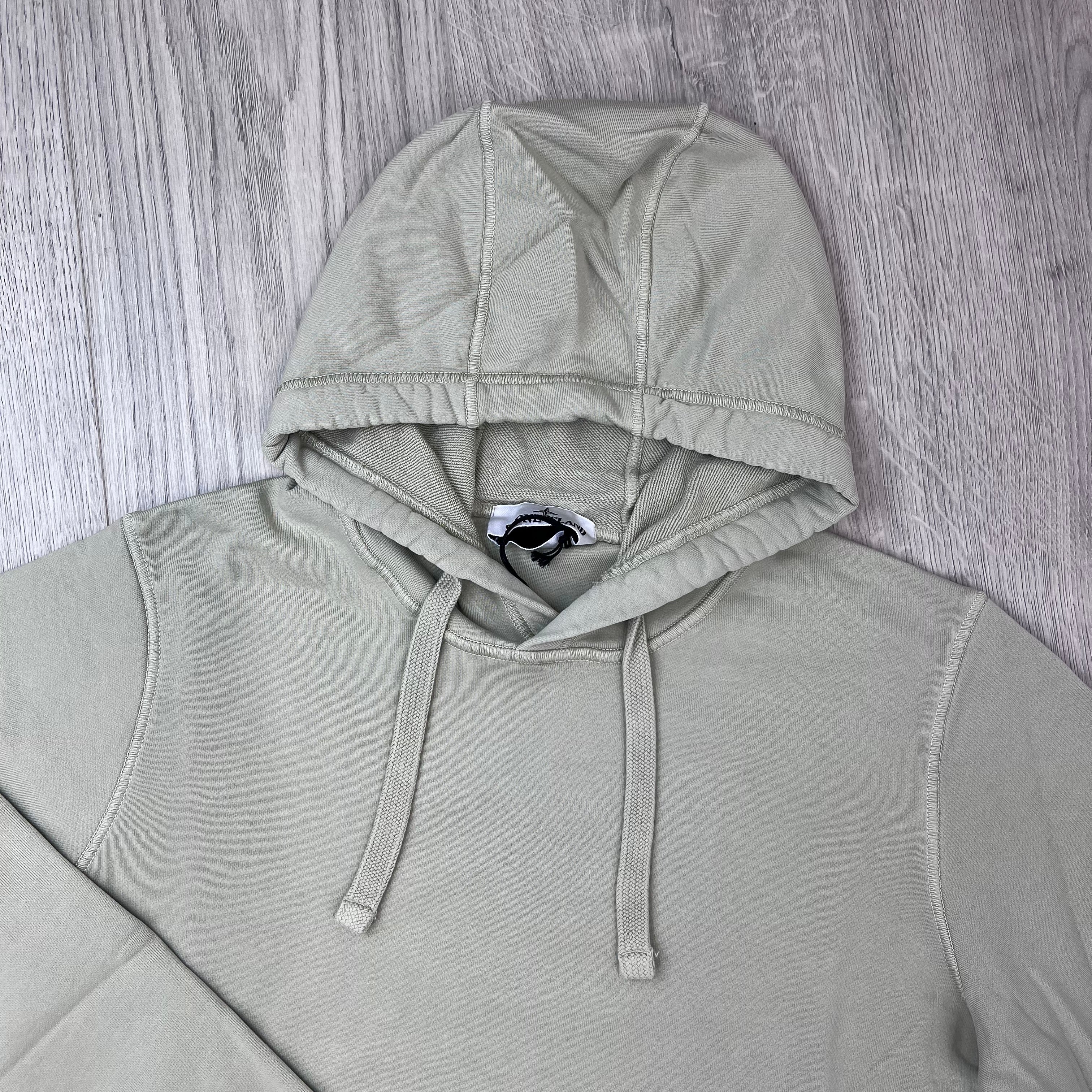 A close up view of the hood and drawstring on a Stone Island Pullover Hoodie in Sand. 
