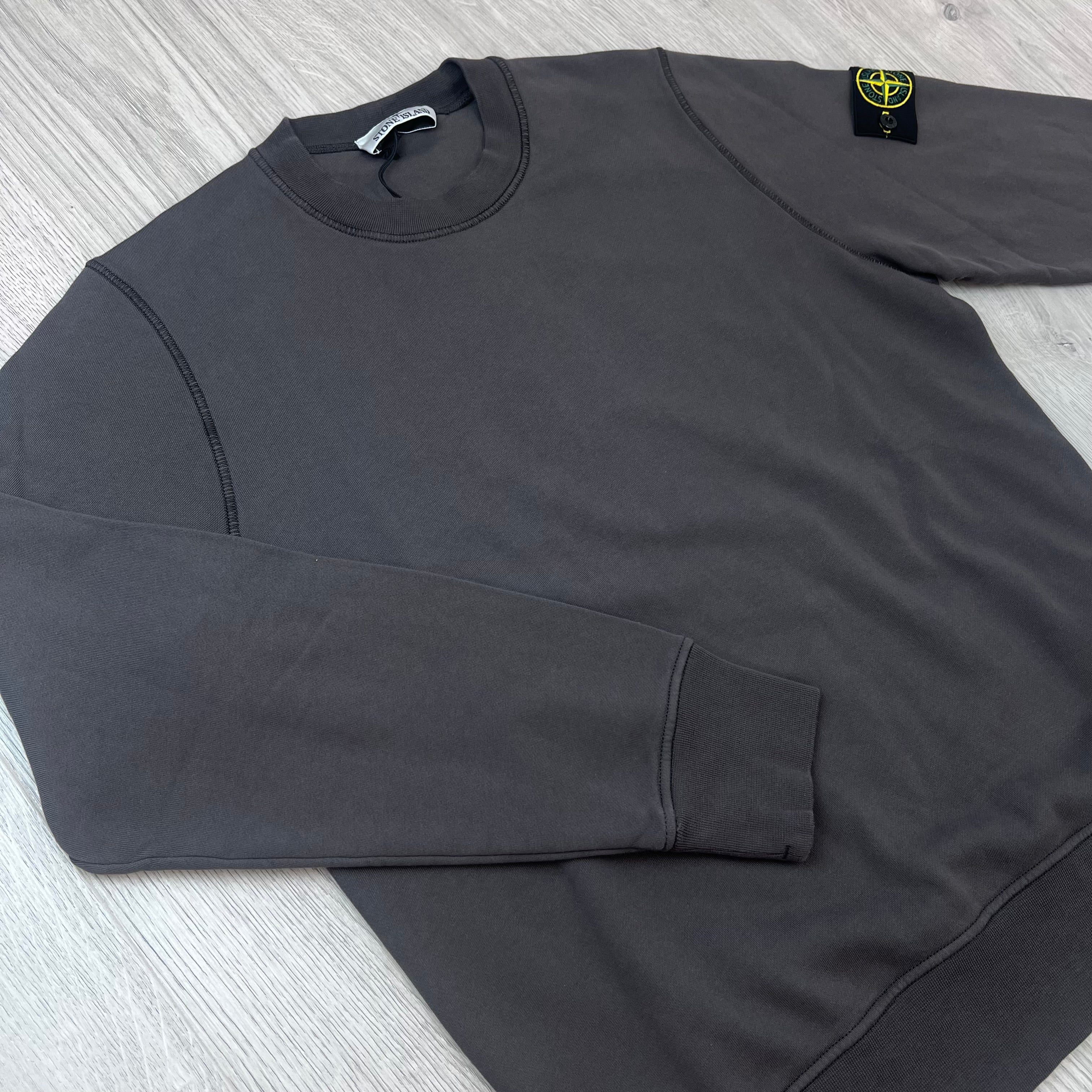 Angled view of the Stone Island Crewneck Sweatshirt in Charcoal Grey.