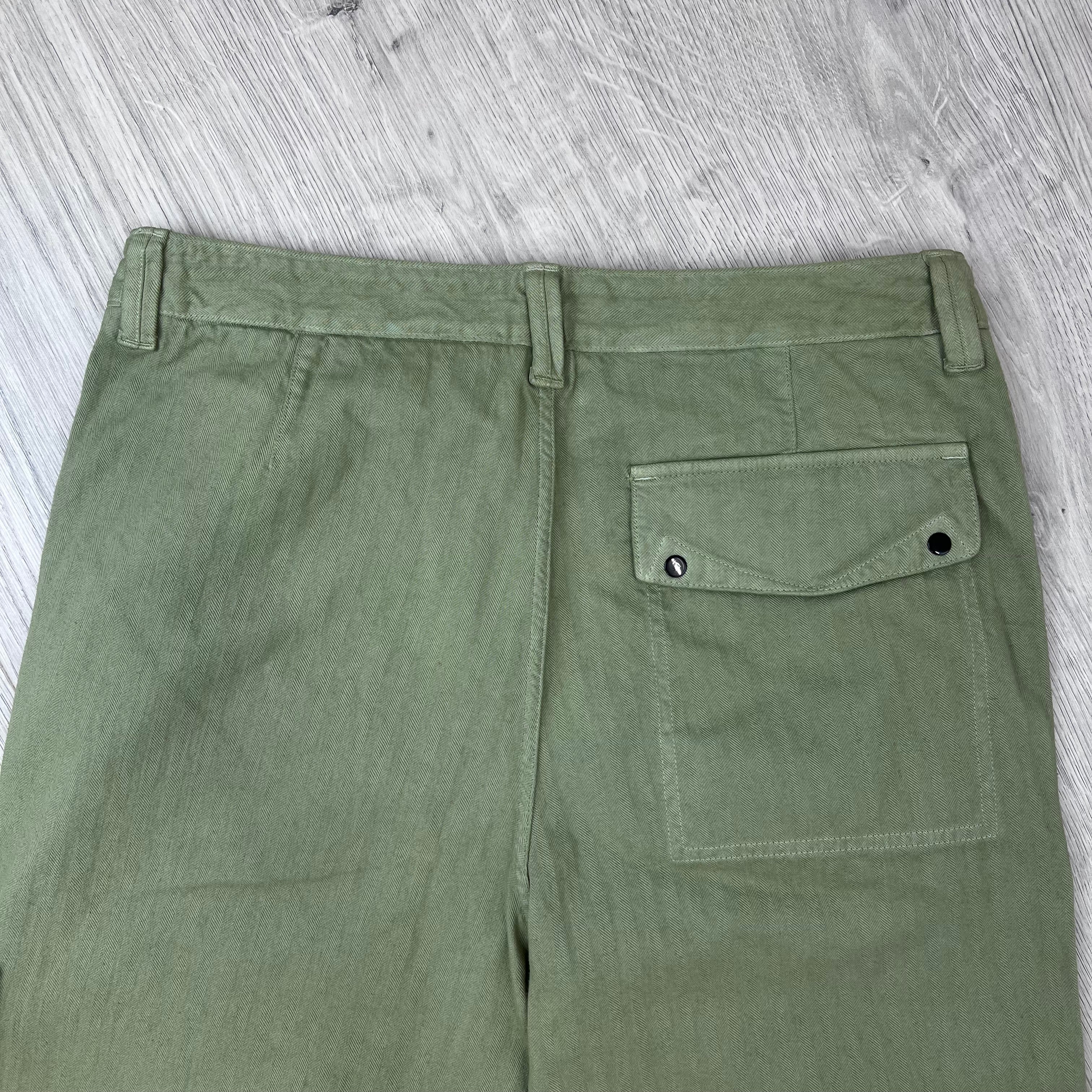 Rear view of the waistband and back patch pocket on the Stone Island Cotton Herringbone Chino Trousers in Laurel Green.