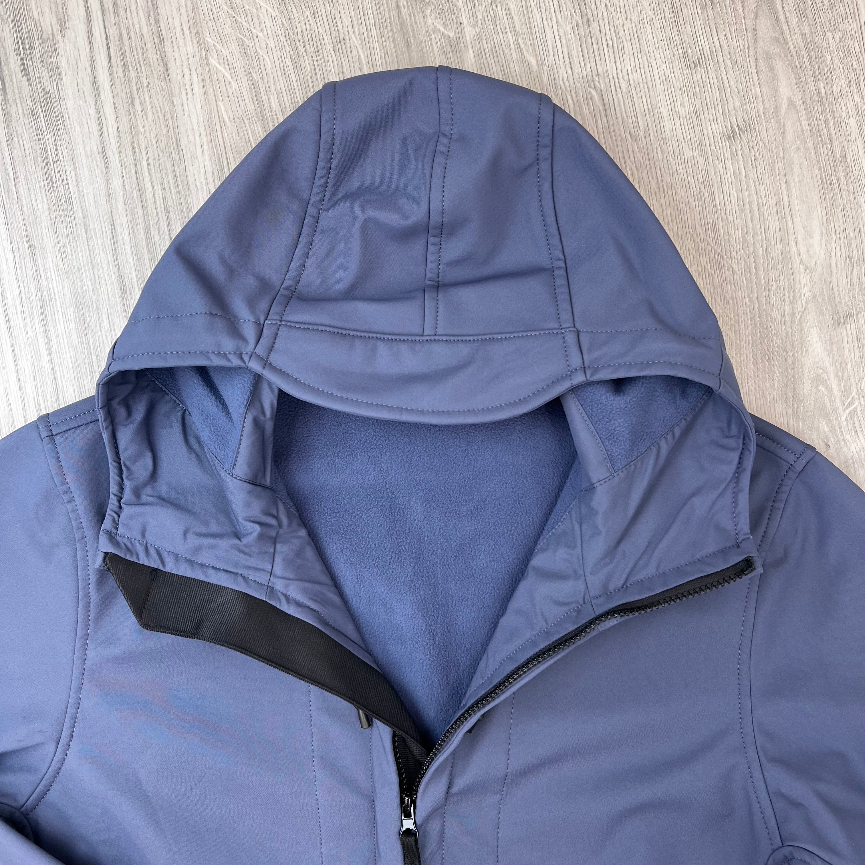 A close up view of the hood on a Stone Island Soft Shell-R_e.dye® Jacket in Slate Blue.